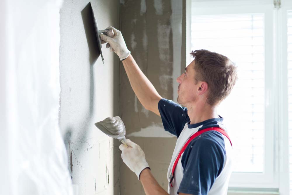 handyman applying plaster